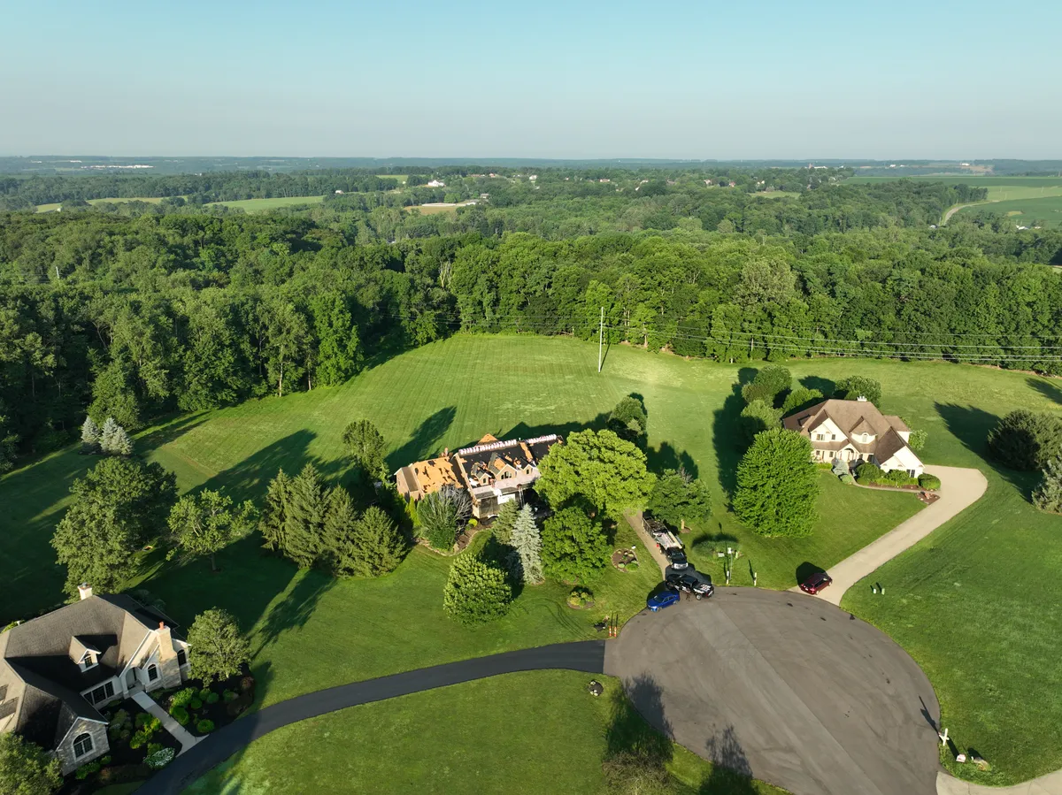 Aerial view of completed roof replacement on brick ranch home in Millersburg Ohio