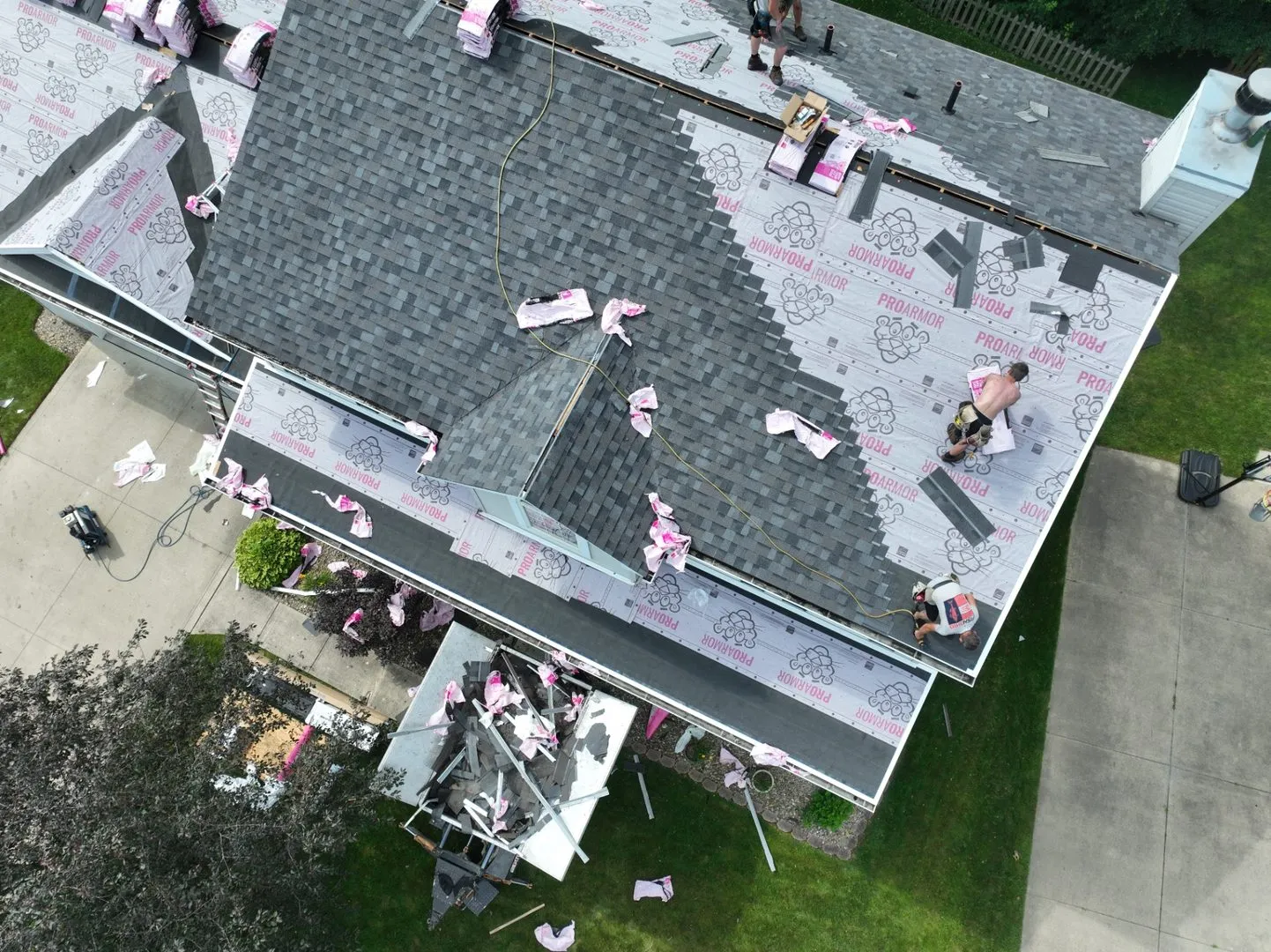Cornerstone crew laying shingle courses on a steep roof section