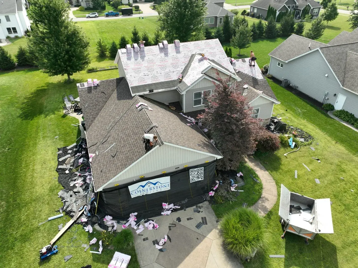 Roof tear-off in progress showing old shingles being removed from Ohio home